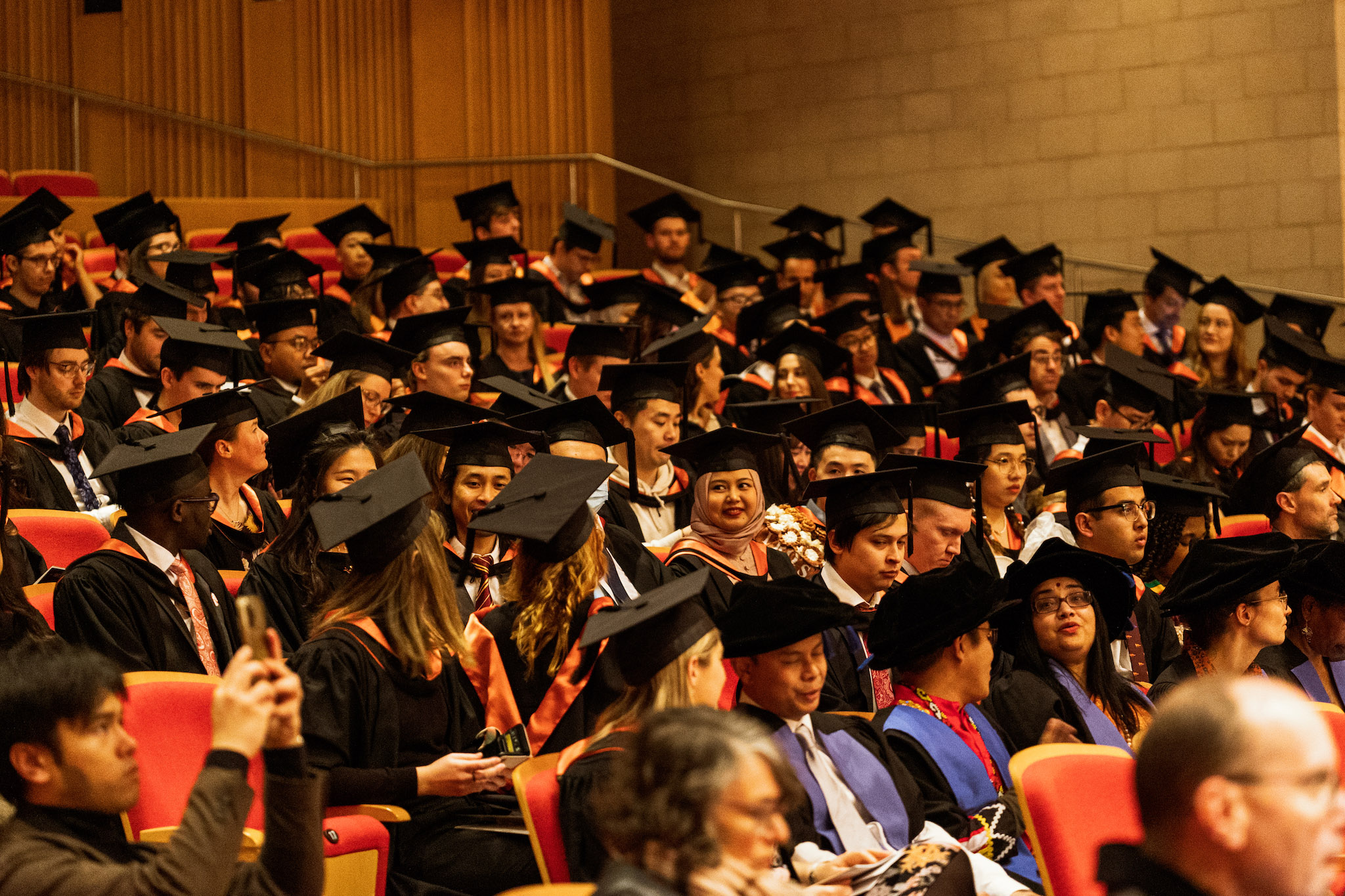 Students gathered in Lewellyn Hall wearing their graduation gowns Students gathered in Lewellyn Hall wearing their graduation gowns
