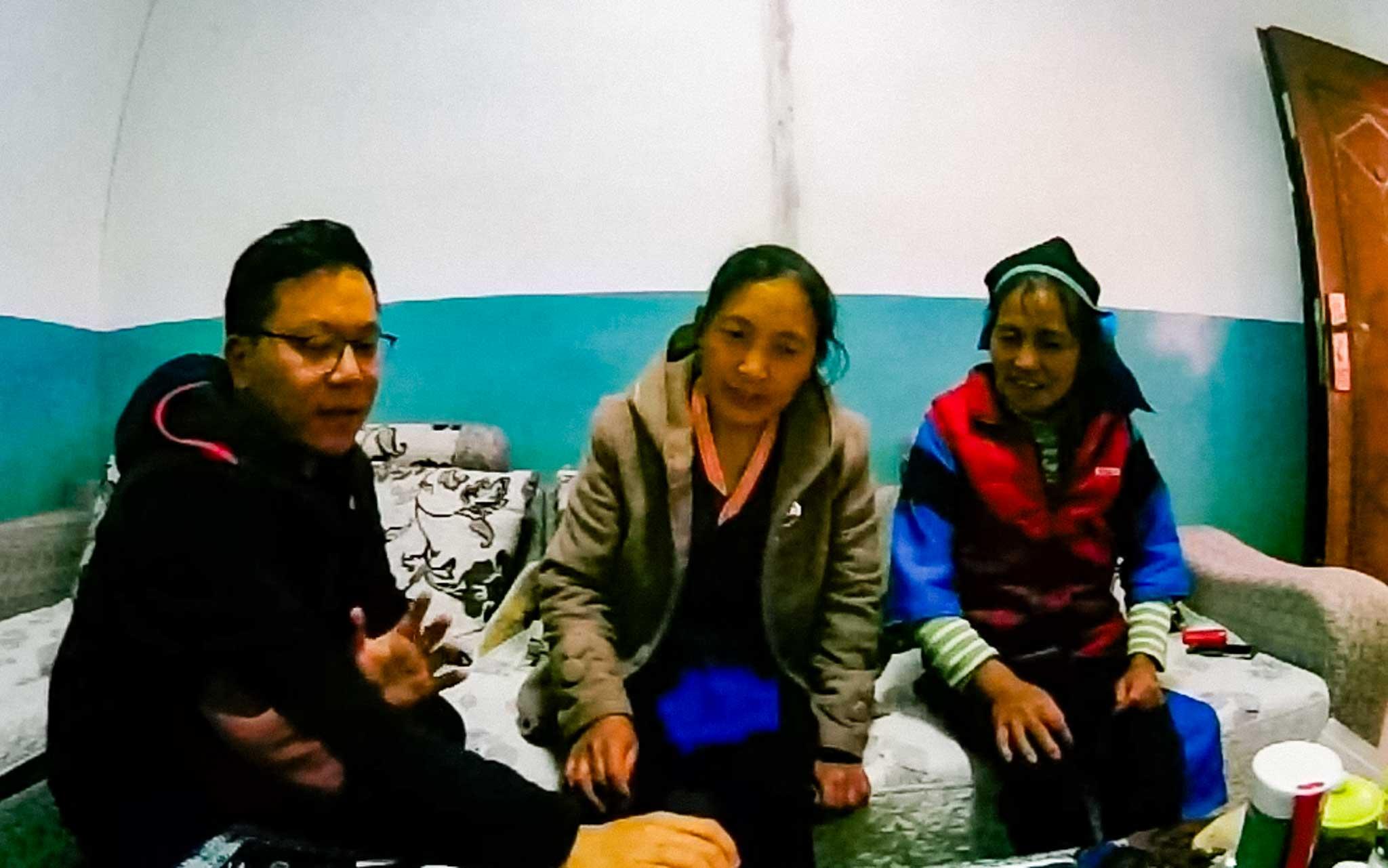 Huade sits with Wuxing villagers conducting his research. Huade sits with Wuxing villagers conducting his research.