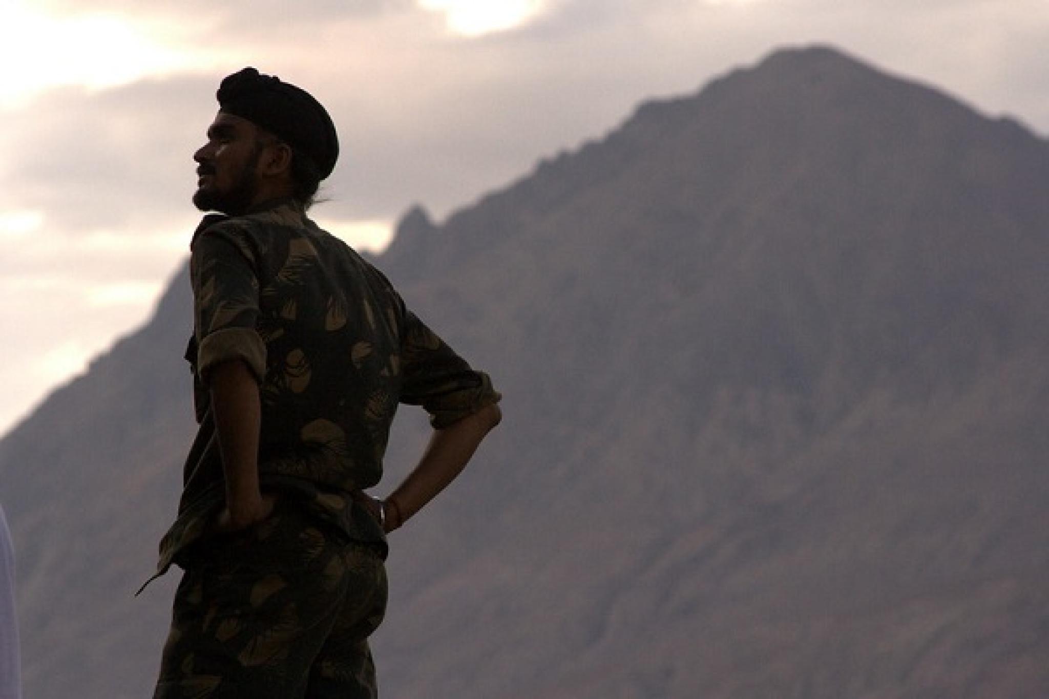 Obscure image of an Indian army jawan (infantryman) standing against the Himalayan backdrop in Nubra valley, Ladakh by Rahul Venkatram on flickr, used under CC BY-NC-ND 2.0 licence.